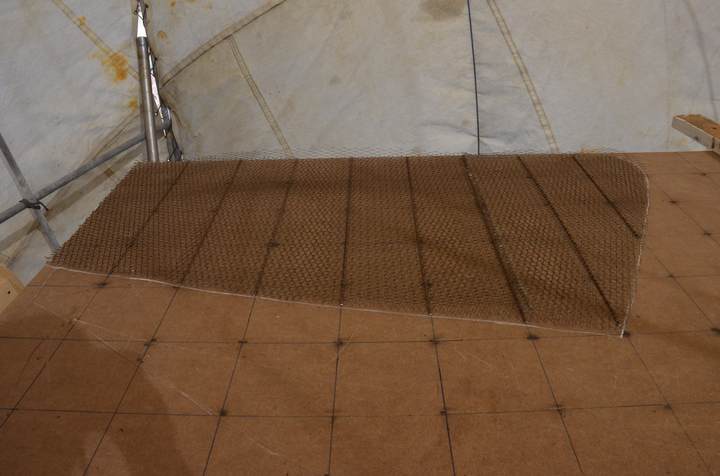 The second layer of expanded steel is then laid on top.  Note the splice.  The expanded steel comes in 1 meter wide rolls and must be joined to maintain the strength of the armature