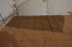 The second layer of expanded steel is then laid on top.  Note the splice.  The expanded steel comes in 1 meter wide rolls and must be joined to maintain the strength of the armature